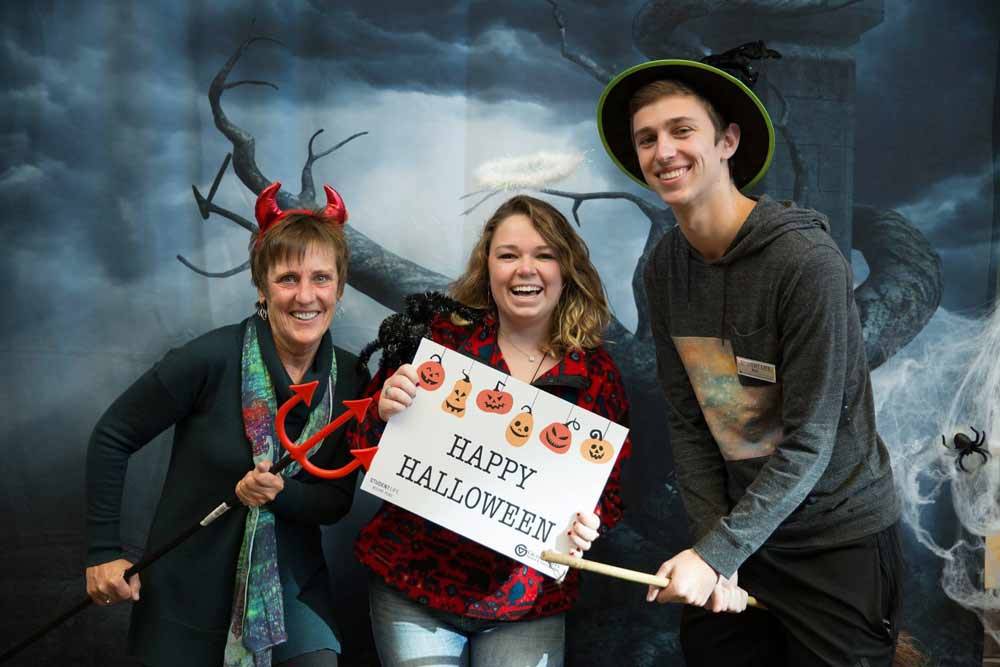 3 Student life employees dressed in Halloween costumes